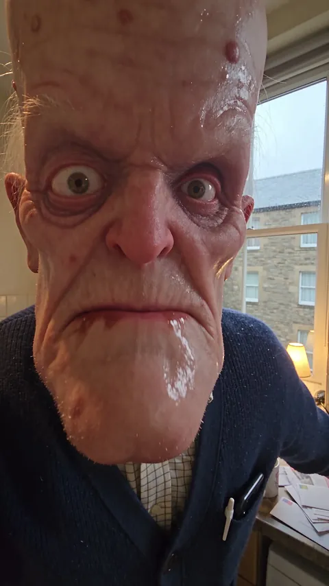 Brian McKenna, retired electrician, at his kitchen in a Glasgow tenement flat